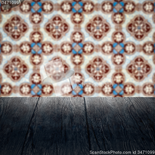 Image of Wood table top and blur vintage ceramic tile pattern wall
