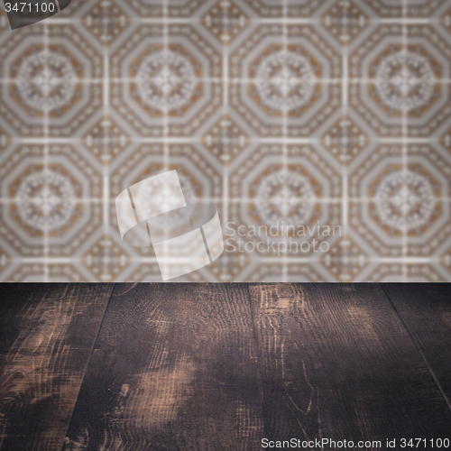 Image of Wood table top and blur vintage ceramic tile pattern wall