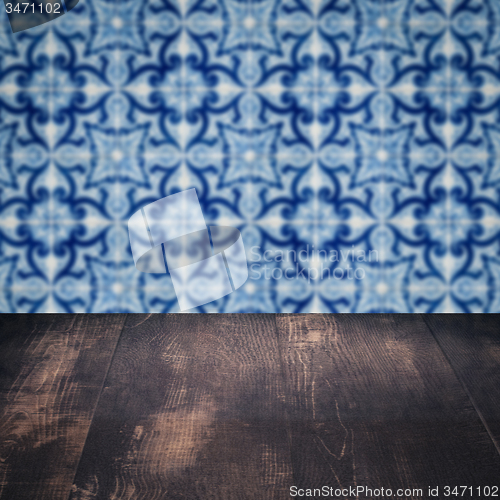 Image of Wood table top and blur vintage ceramic tile pattern wall