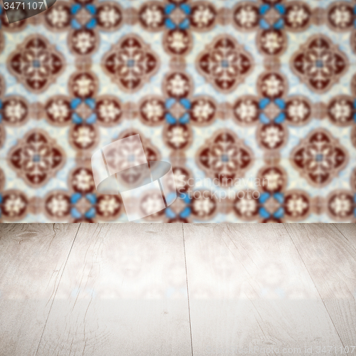 Image of Wood table top and blur vintage ceramic tile pattern wall