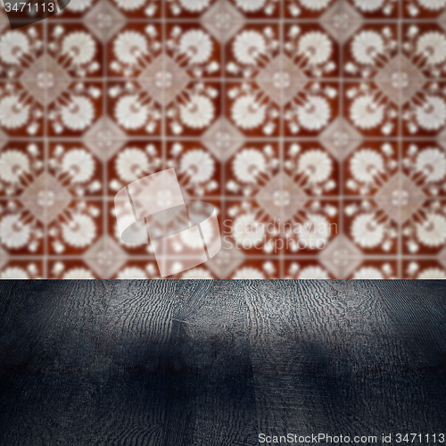 Image of Wood table top and blur vintage ceramic tile pattern wall
