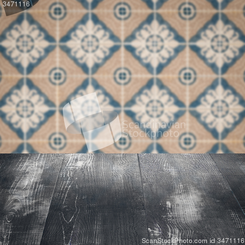 Image of Wood table top and blur vintage ceramic tile pattern wall