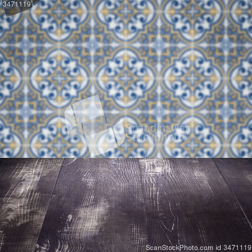 Image of Wood table top and blur vintage ceramic tile pattern wall