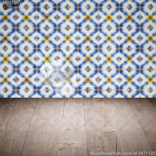 Image of Wood table top and blur vintage ceramic tile pattern wall