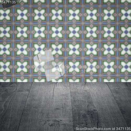 Image of Wood table top and blur vintage ceramic tile pattern wall