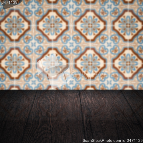 Image of Wood table top and blur vintage ceramic tile pattern wall