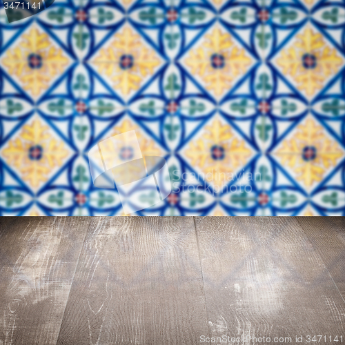 Image of Wood table top and blur vintage ceramic tile pattern wall
