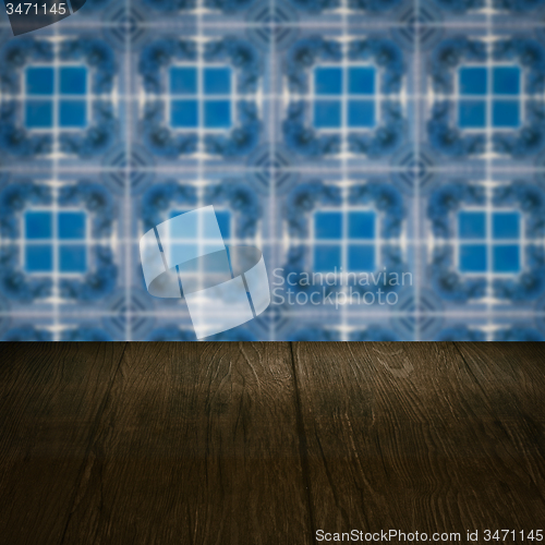 Image of Wood table top and blur vintage ceramic tile pattern wall