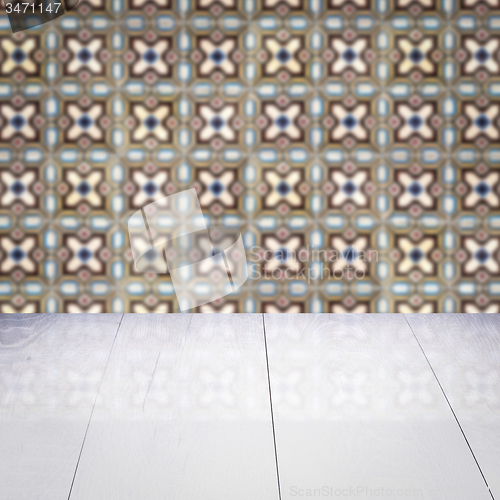 Image of Wood table top and blur vintage ceramic tile pattern wall