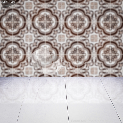 Image of Wood table top and blur vintage ceramic tile pattern wall