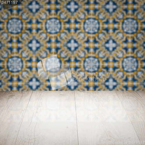 Image of Wood table top and blur vintage ceramic tile pattern wall
