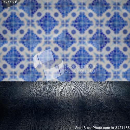Image of Wood table top and blur vintage ceramic tile pattern wall