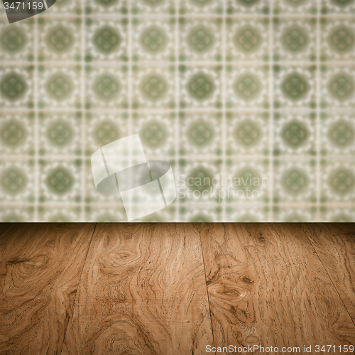 Image of Wood table top and blur vintage ceramic tile pattern wall