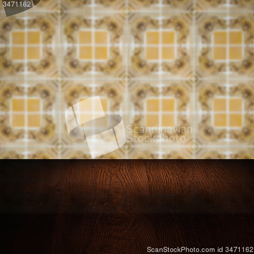 Image of Wood table top and blur vintage ceramic tile pattern wall