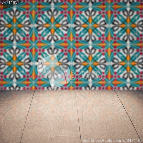 Image of Wood table top and blur vintage ceramic tile pattern wall