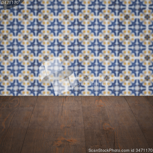 Image of Wood table top and blur vintage ceramic tile pattern wall