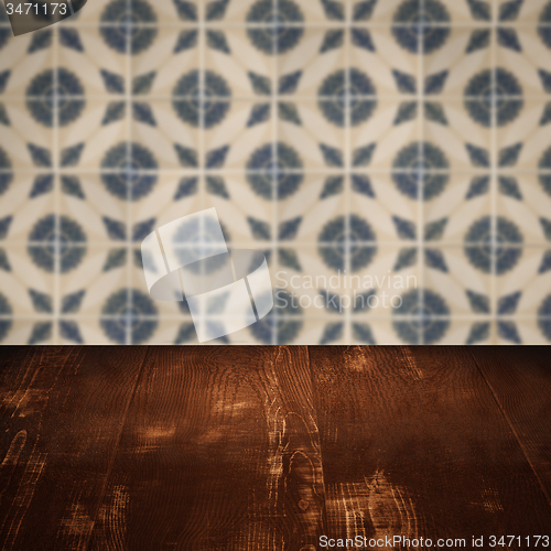 Image of Wood table top and blur vintage ceramic tile pattern wall