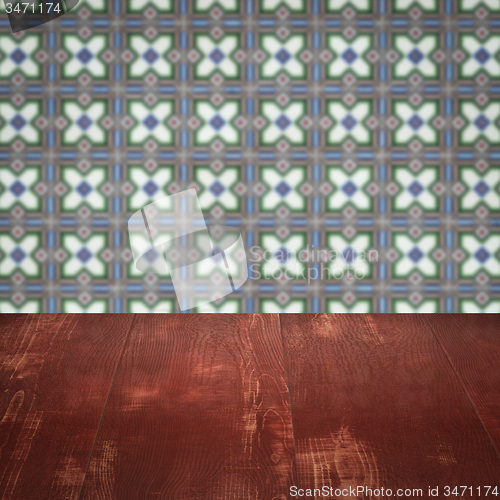 Image of Wood table top and blur vintage ceramic tile pattern wall