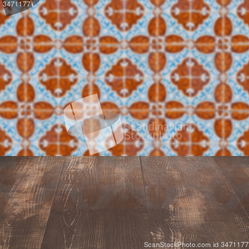 Image of Wood table top and blur vintage ceramic tile pattern wall