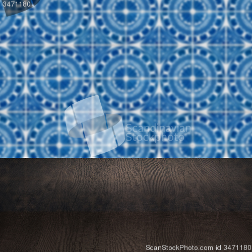 Image of Wood table top and blur vintage ceramic tile pattern wall