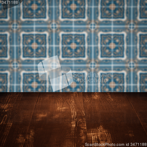 Image of Wood table top and blur vintage ceramic tile pattern wall