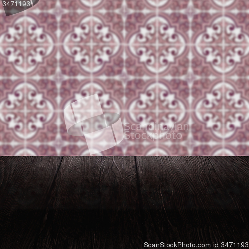 Image of Wood table top and blur vintage ceramic tile pattern wall