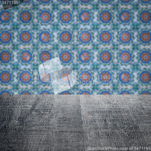 Image of Wood table top and blur vintage ceramic tile pattern wall