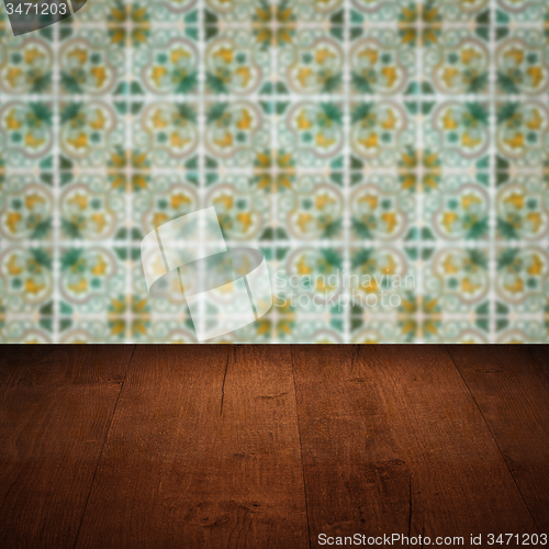 Image of Wood table top and blur vintage ceramic tile pattern wall