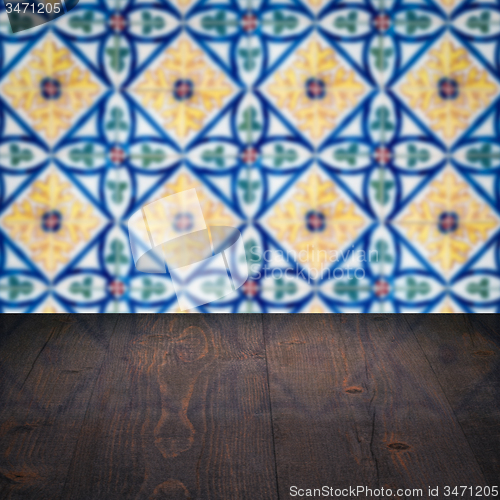 Image of Wood table top and blur vintage ceramic tile pattern wall