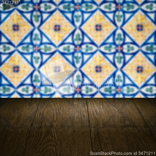 Image of Wood table top and blur vintage ceramic tile pattern wall