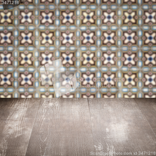 Image of Wood table top and blur vintage ceramic tile pattern wall