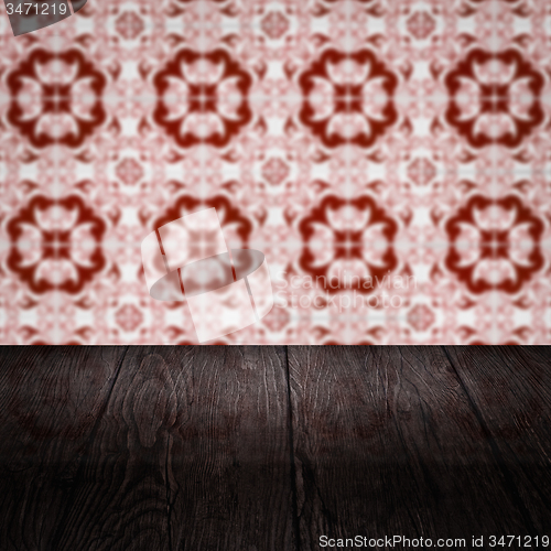 Image of Wood table top and blur vintage ceramic tile pattern wall