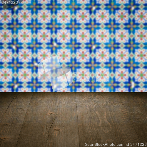 Image of Wood table top and blur vintage ceramic tile pattern wall