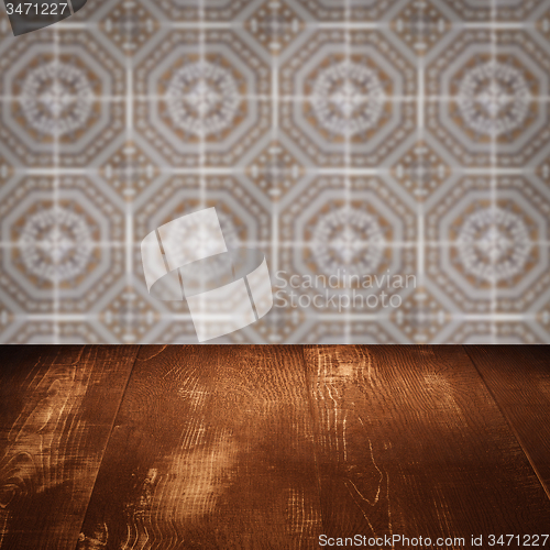 Image of Wood table top and blur vintage ceramic tile pattern wall