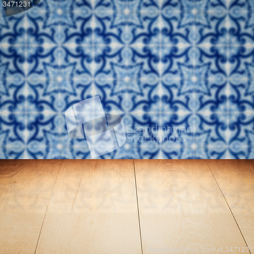 Image of Wood table top and blur vintage ceramic tile pattern wall
