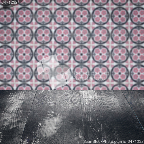 Image of Wood table top and blur vintage ceramic tile pattern wall