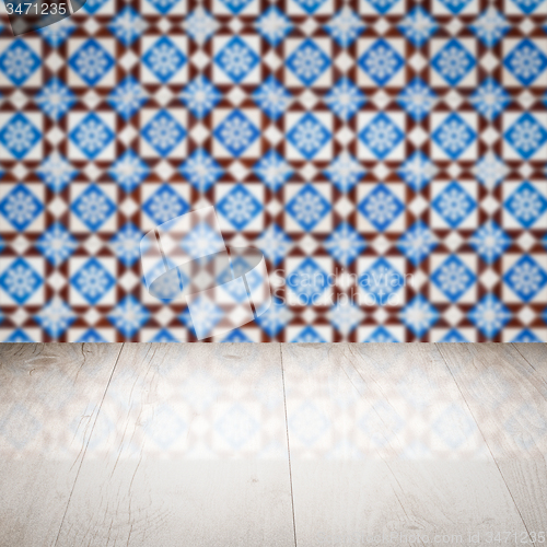 Image of Wood table top and blur vintage ceramic tile pattern wall