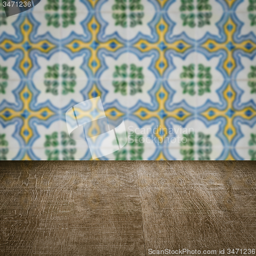 Image of Wood table top and blur vintage ceramic tile pattern wall
