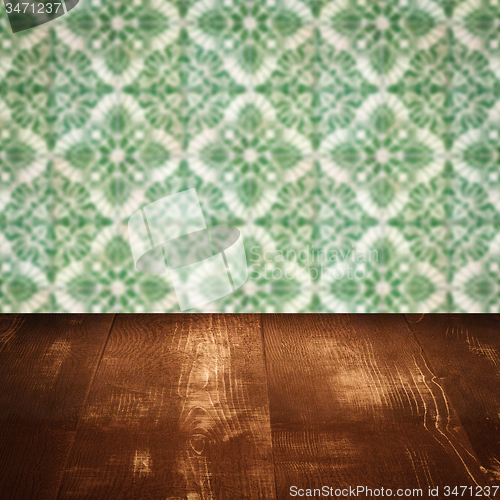 Image of Wood table top and blur vintage ceramic tile pattern wall
