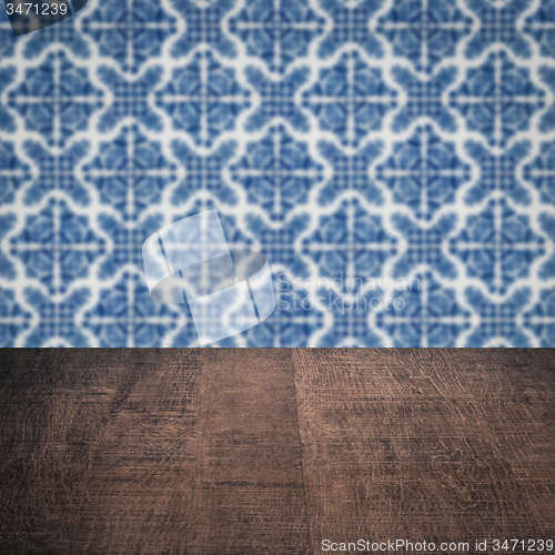 Image of Wood table top and blur vintage ceramic tile pattern wall