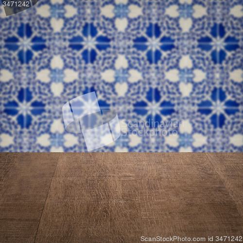 Image of Wood table top and blur vintage ceramic tile pattern wall