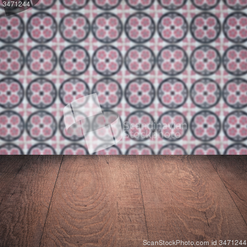 Image of Wood table top and blur vintage ceramic tile pattern wall