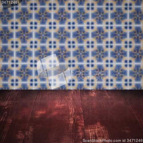 Image of Wood table top and blur vintage ceramic tile pattern wall