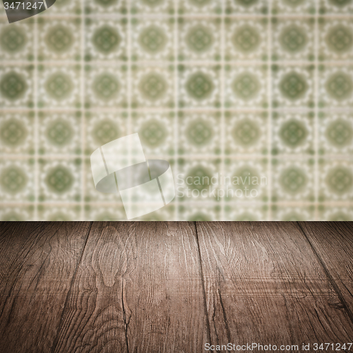 Image of Wood table top and blur vintage ceramic tile pattern wall