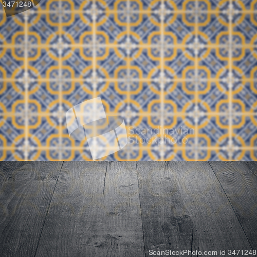 Image of Wood table top and blur vintage ceramic tile pattern wall