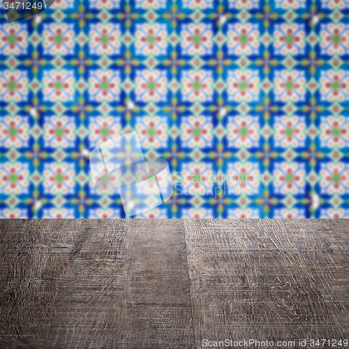 Image of Wood table top and blur vintage ceramic tile pattern wall