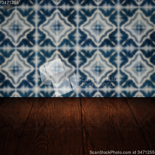 Image of Wood table top and blur vintage ceramic tile pattern wall