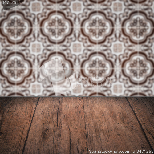 Image of Wood table top and blur vintage ceramic tile pattern wall