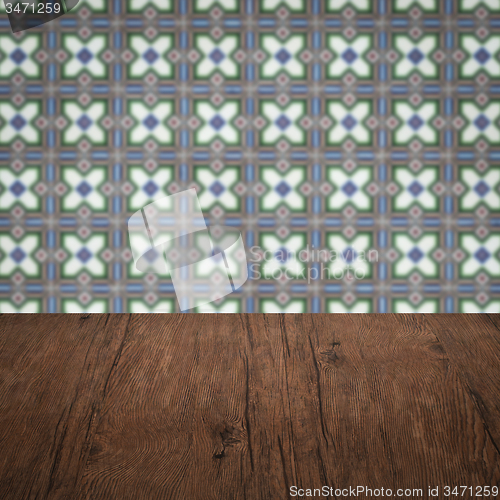 Image of Wood table top and blur vintage ceramic tile pattern wall
