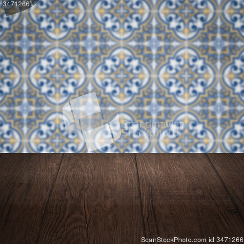 Image of Wood table top and blur vintage ceramic tile pattern wall